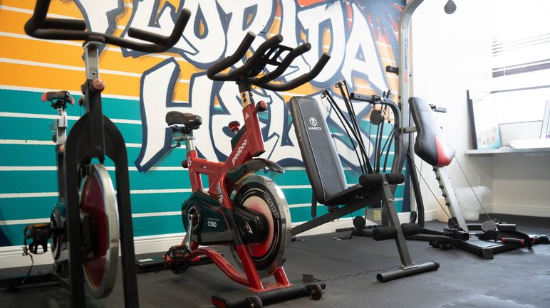 On-site fitness room with exercise bikes at the Florida Helps center