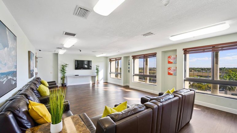 Comfortable resident lounge with sofas and large windows